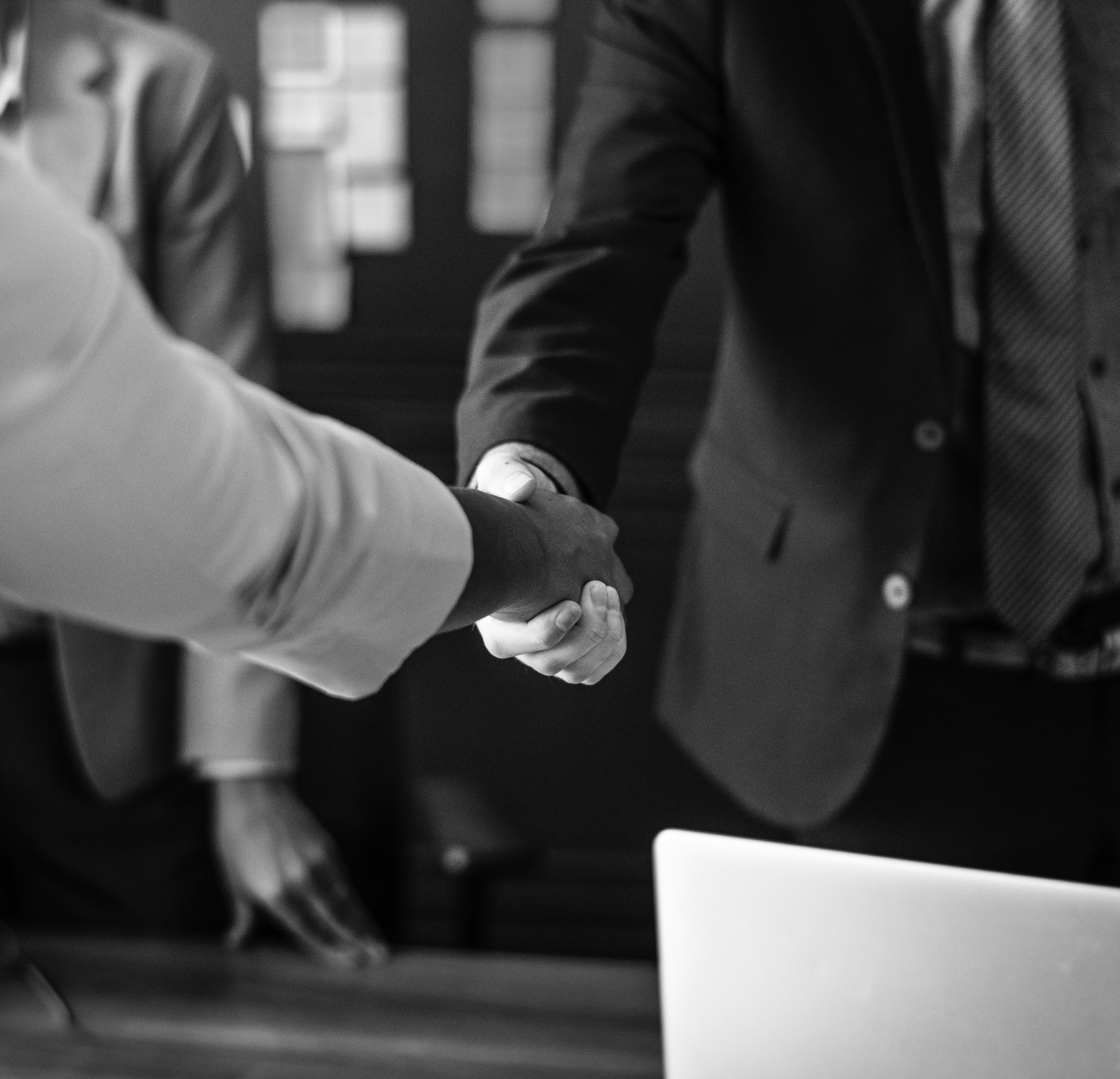 black and white image of two people shaking hands