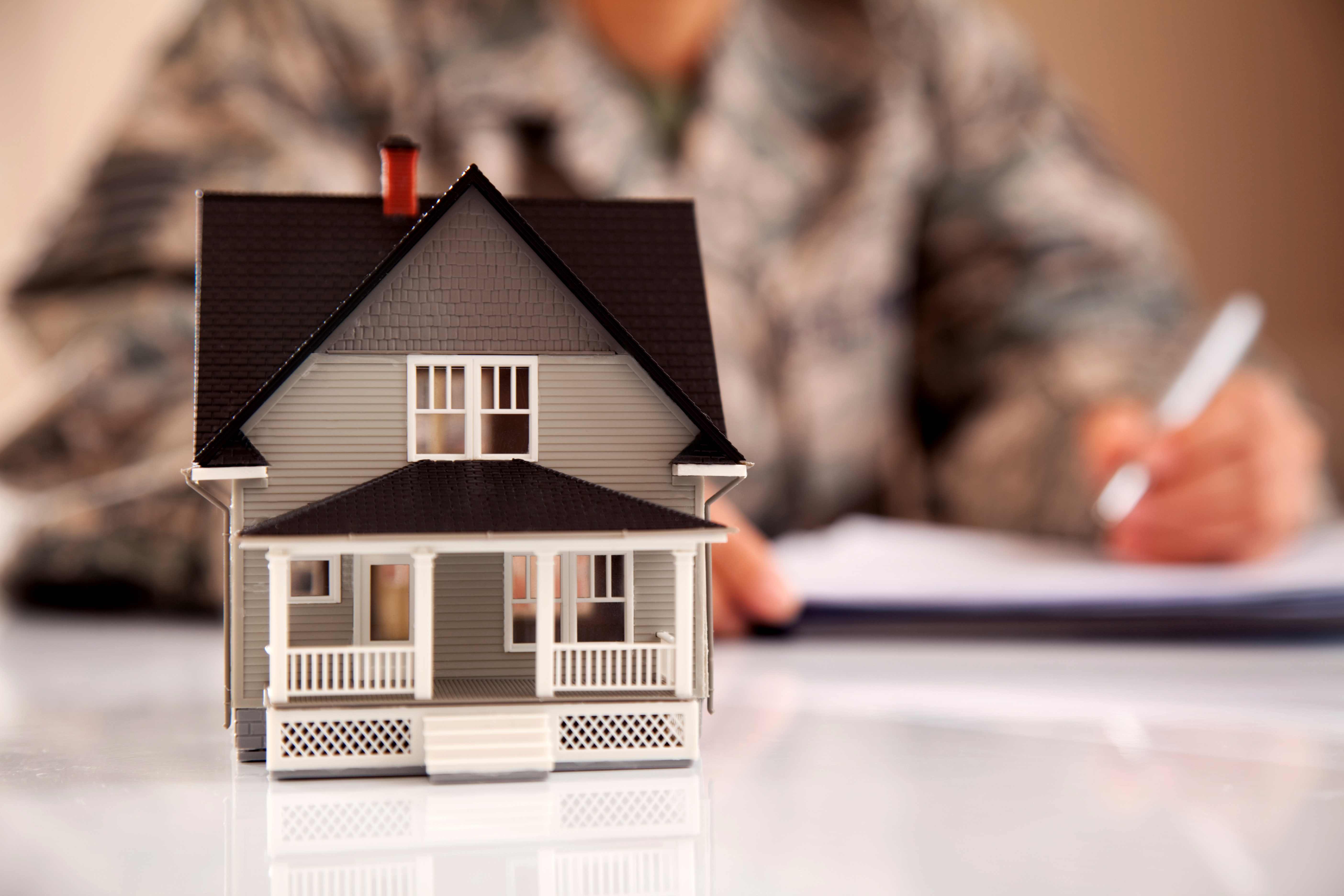 Grey House With Military Uniformed Man Signing A Contract