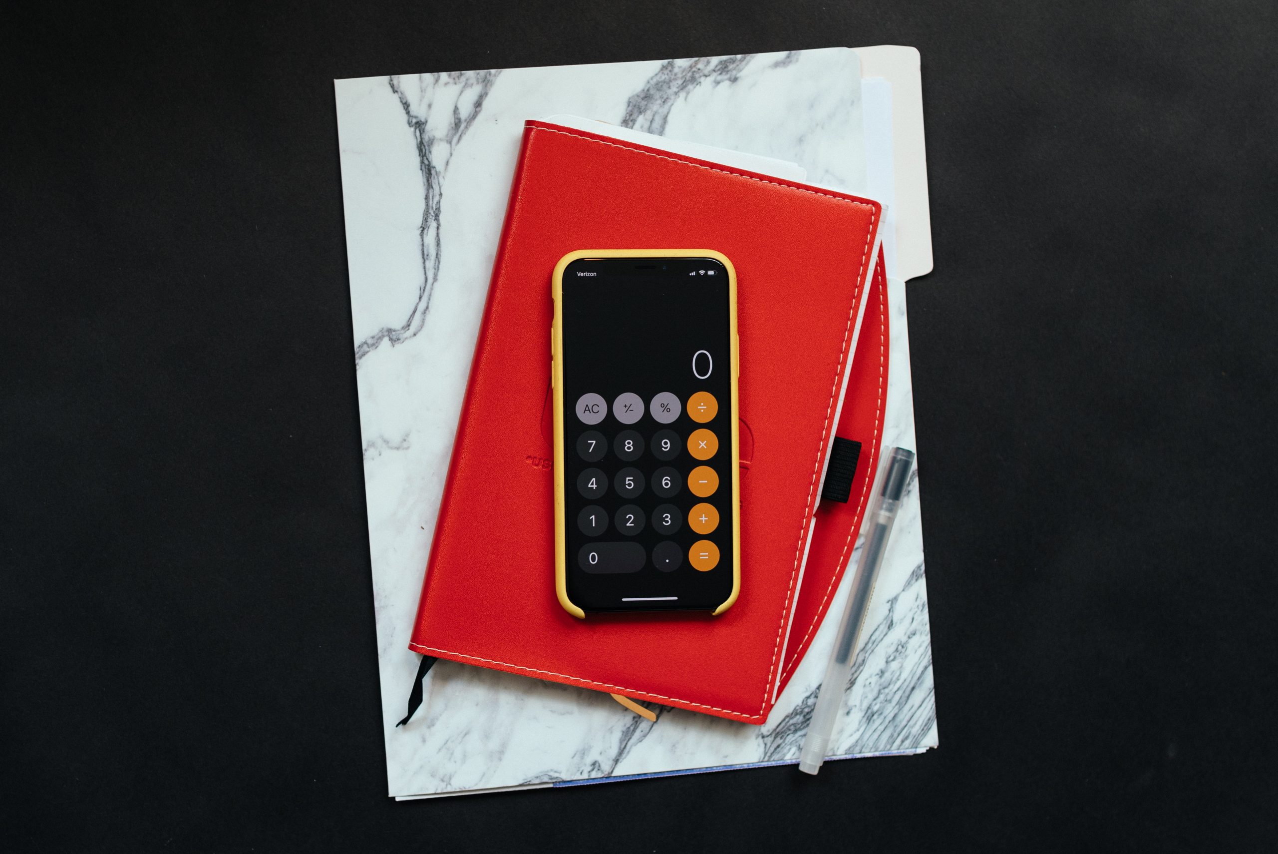 Calculator On Red And Marbled Folder