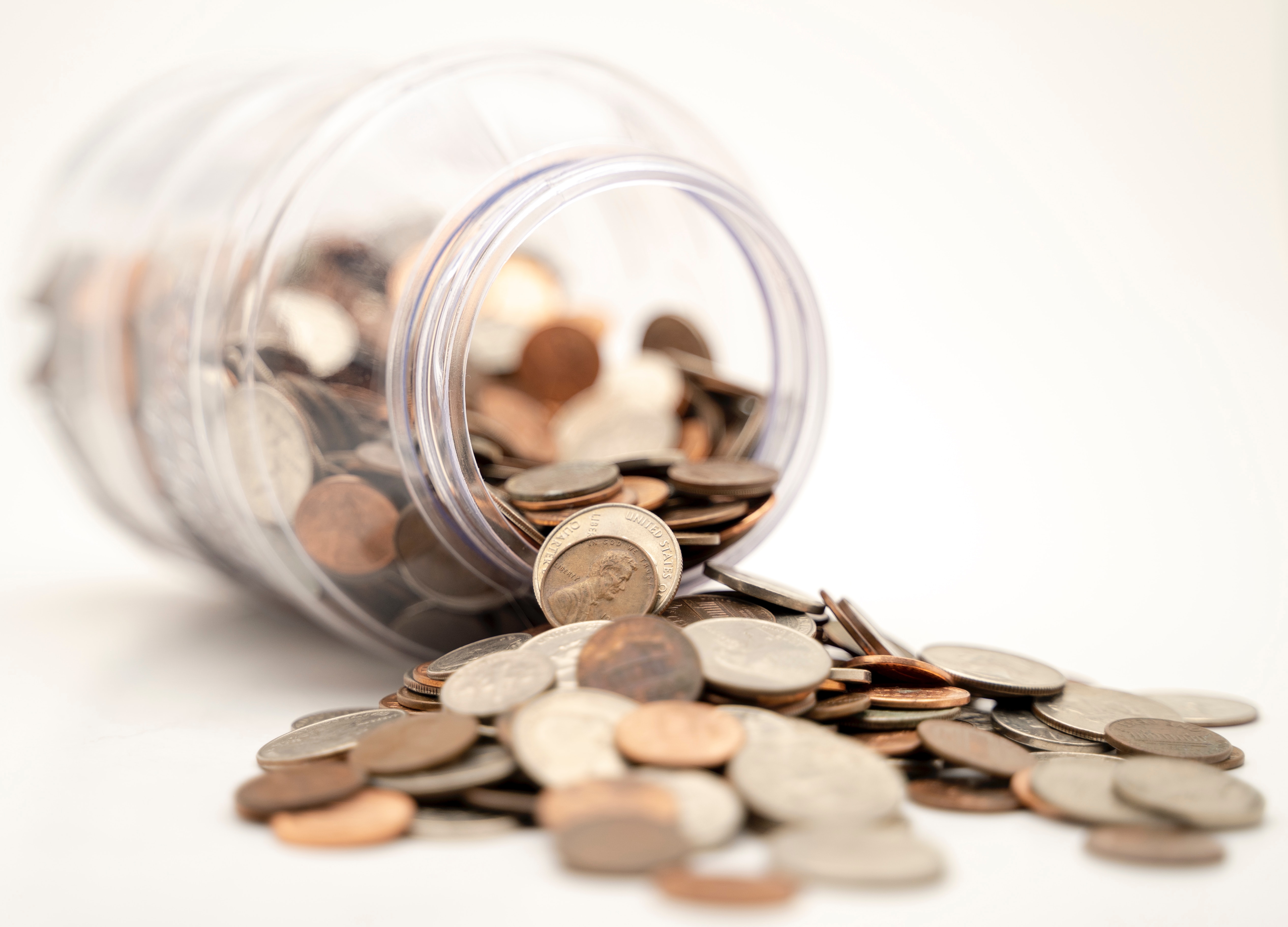 Mason Jar Tipped Over With Money Pouring Out