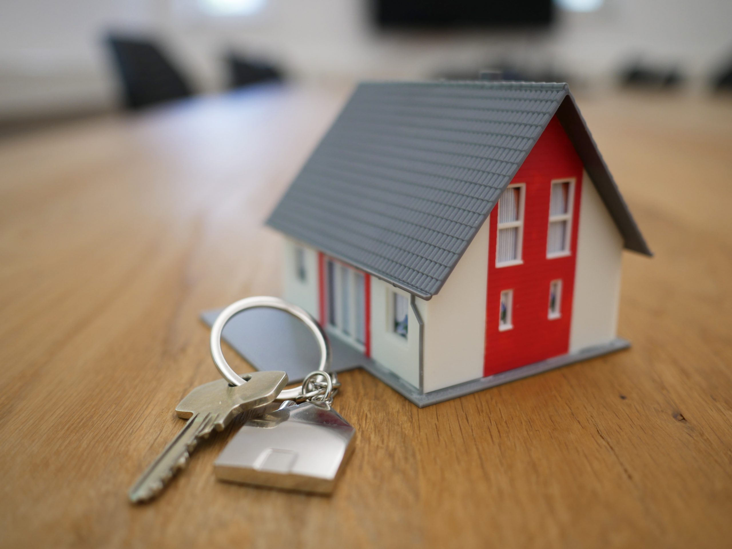 Red And White Toy House On Tabletop With Keys