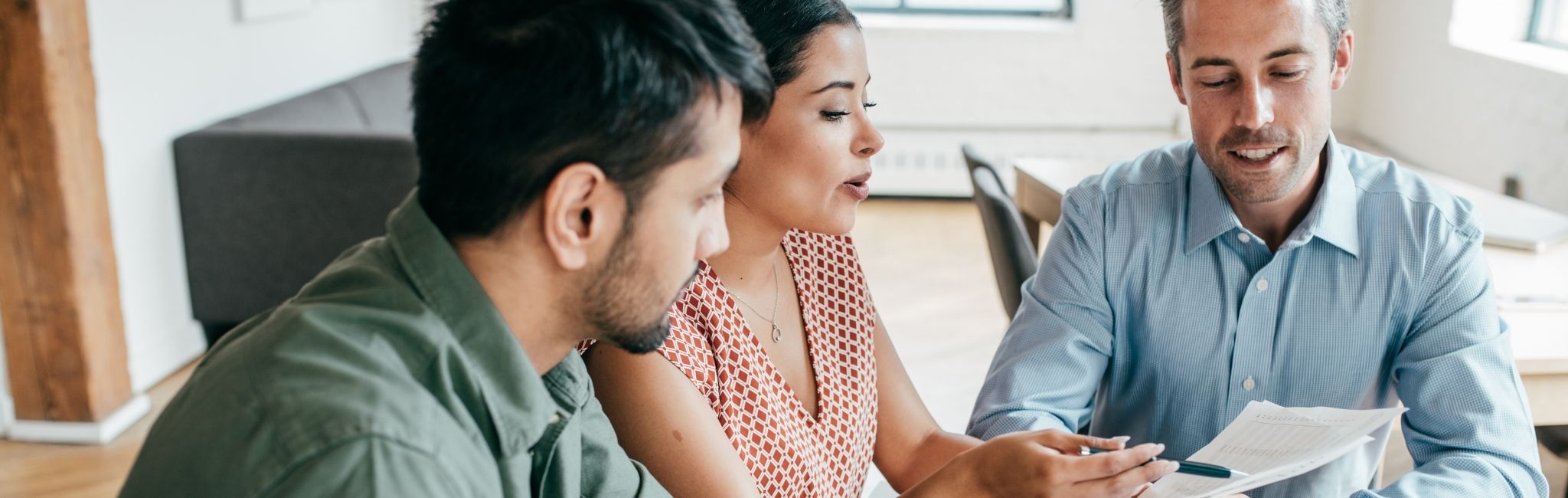 Homebuyers reviewing mortgage loan options with HUNT Mortgage